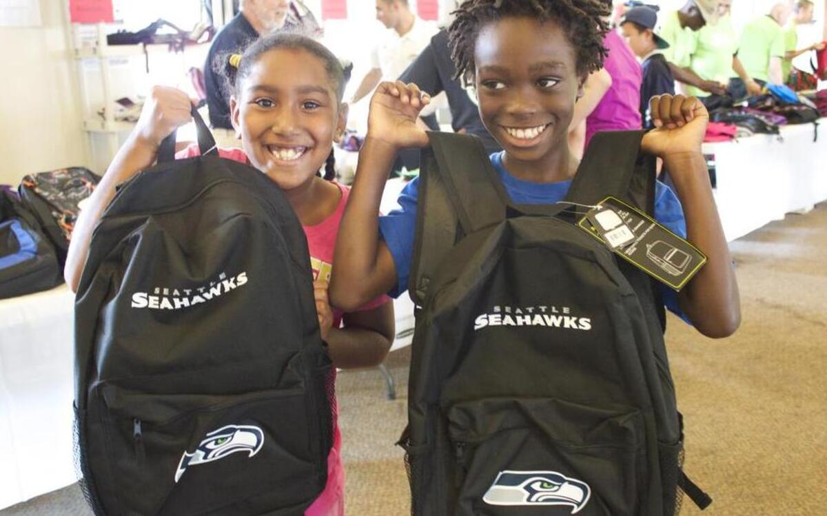 
A couple of excited students show off backpacks they received at a previous Back-to-School Barbecue at Mountain View Community Center.
