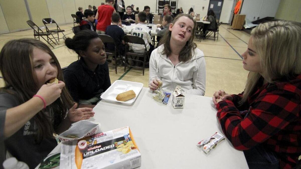 Pierce College student and mentor Kaylee Moegrageli, right, talks with Ridgecrest Elementary School students Alexia Huffman, Chanelle Stokes, Khamara Hayden, from left, during a visit last week at the school. Pierce students mentor the younger students as part of an ongoing partnership between the schools.