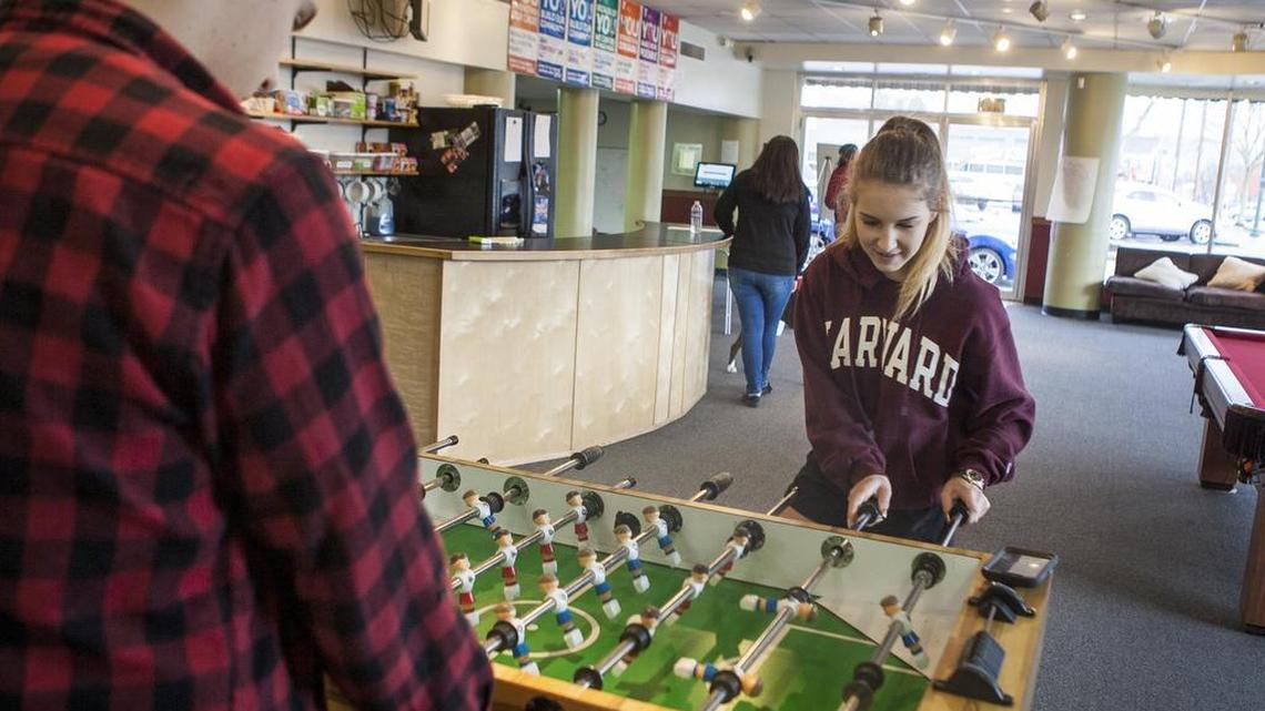Elisha Roberts, left, and Ana Myers play foosball at the Youth Investment Center in Puyallup last week. This month, the center celebrated 10 years of empowering at-risk youth in junior and senior high.
