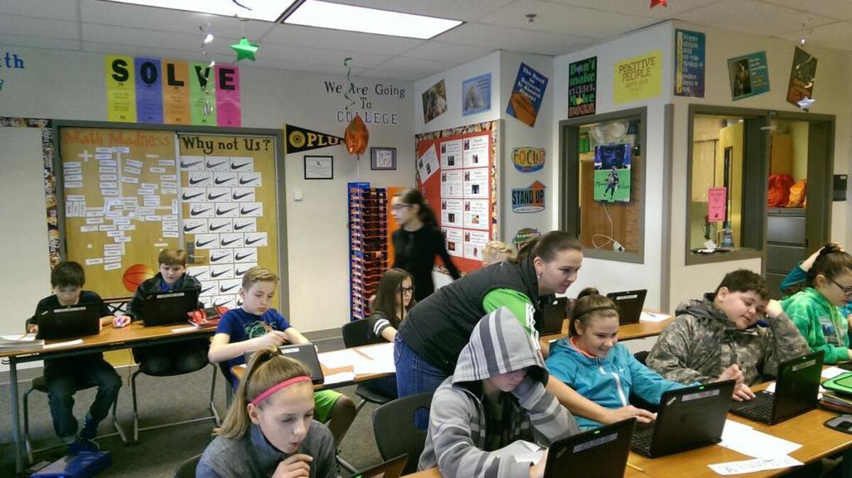 Amy Tutty, a sixth grade teacher at Edgerton Elementary School’s “Classroom of the Future,” helps student McKenna Whitney with a question. Tutty says engagement has skyrocketed since introducing laptops and other digital learning tools to students.