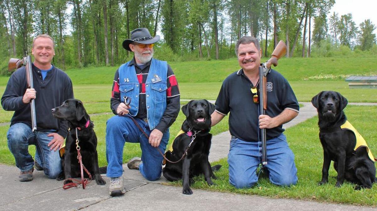 Machinists Union Local Lodge 751-C members Rod Sigvartson, left, and Loren Guzzone, right, pose with Guide Dogs of America volunteer Steve Jacquay at the 2014 Bucks for Pups charity shoot at the Sumner Sportsmen’s Association range in Puyallup.