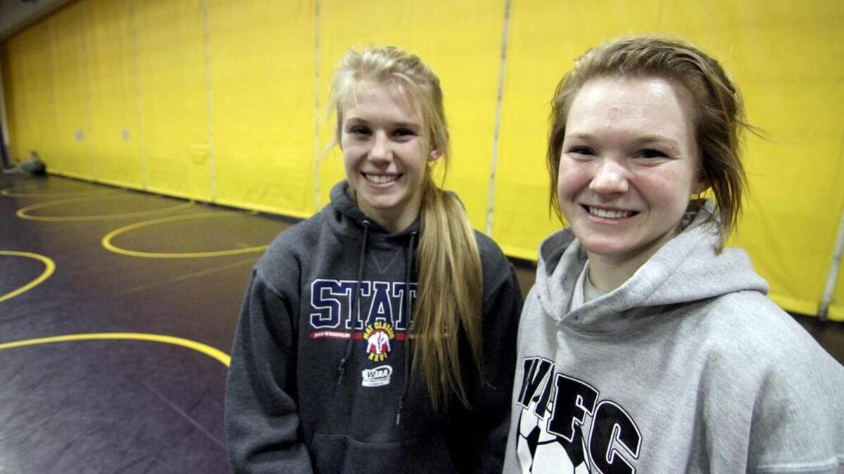 Brooklyn, left, and her sister Jordyn, a senior, both wrestle on the Puyallup High team. This is the sisters’ final year wrestling together, and both hope to go out with a bang at Mat Classic.