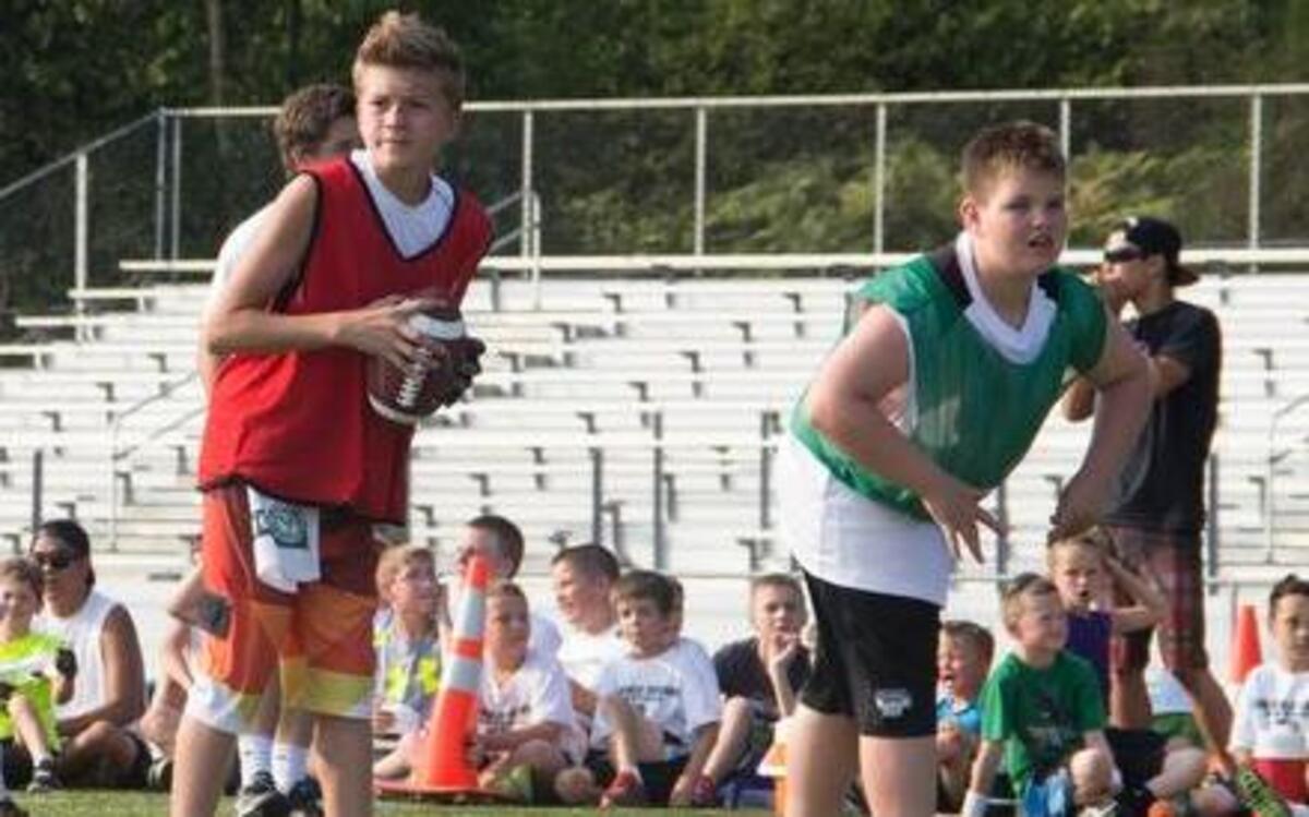 
Kole Kavanaugh, center, an eighth-grader at Ferrucci Junior High, prepares for a play in a scrimmage game July 8 at Jag Football Camp at Emerald Ridge High School.
