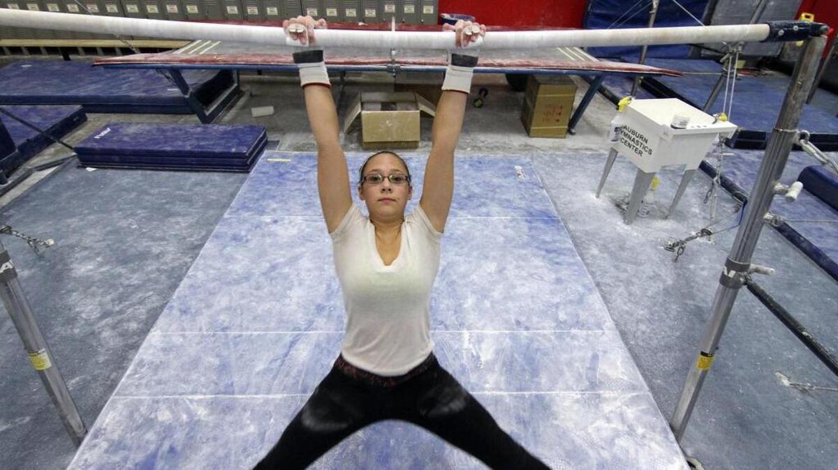 Sumner High School gymnast Ashlee Tarro hits the parallel bars at the Auburn Gymnastics Center last week during an extra team practice.
