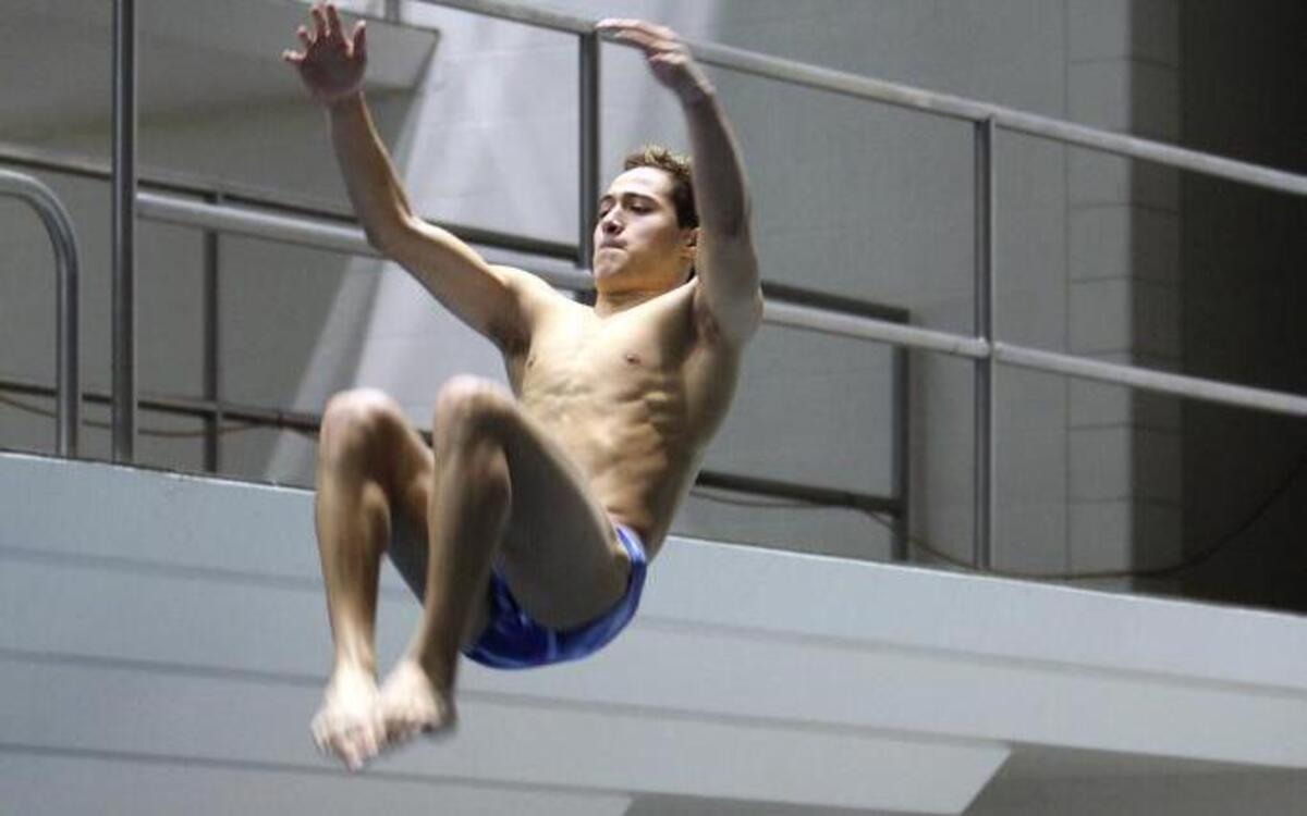 Sumner High School diver Rafael Rodriguez launches from the diving board during the Class 3A state swimming and diving meet on Friday at the King County Aquatic Center in Federal Way.