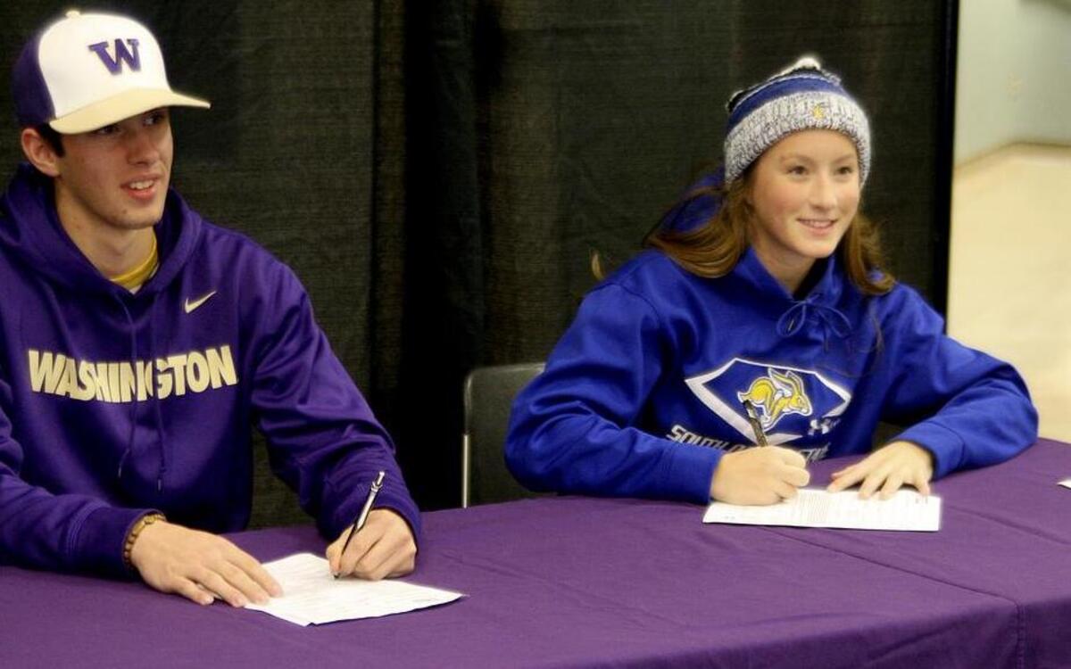 Puyallup High pitcher Chris Micheles signed his letter of intent with Washington, left, while classmate Emily Enrud signed her to play softball at South Dakota State last week.