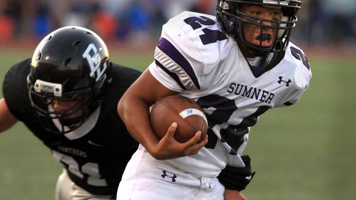 Sumner High’s Lokahi Kamau attempts to break the tackle of Bonney Lake’s Hunter Coughlin during a Sept. 9, 2011 rivalry game at Sunset Chev Stadium between the two high schools in the same district. The recent reclassifications — along with the movement and creation of new leagues — have put some classic rivalry games at risk.