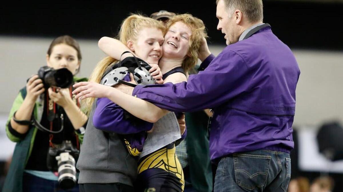 Puyallup’s Jordyn Bartelson celebrates her state title with hugs.