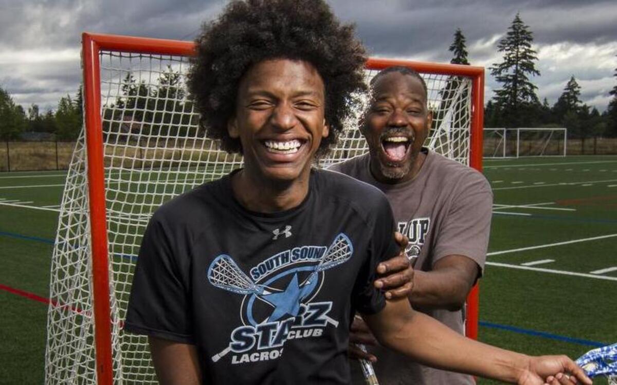 Emerald Ridge High graduate Hassan Mackey and his father, Larry Mackey, stand for a portrait. Larry has used his perseverance through a difficult childhood to help his family remain strong through tough times.