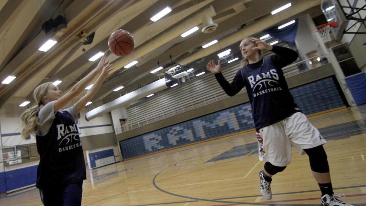 Rogers High teammates and longtime friends Tristan Coltom, left, and Jesse Westering execute a drill at the school earlier this year. The two soon-to-be seniors are putting their focus this summer on getting in shape for the upcoming season.