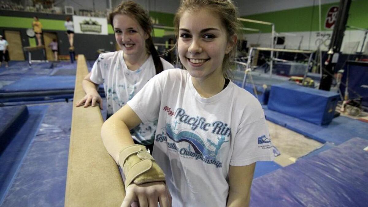 Puyallup High gymnasts Natalie Crouch, left, and Olivia Gamache lead the Vikings into this weekend’s state qualifying meet.
