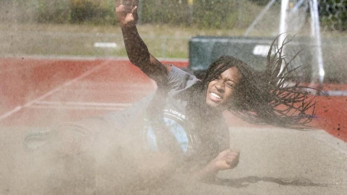 Emerald Ridge High’s Audrey Fernandez lands a triple jump during practice last week at the high school.