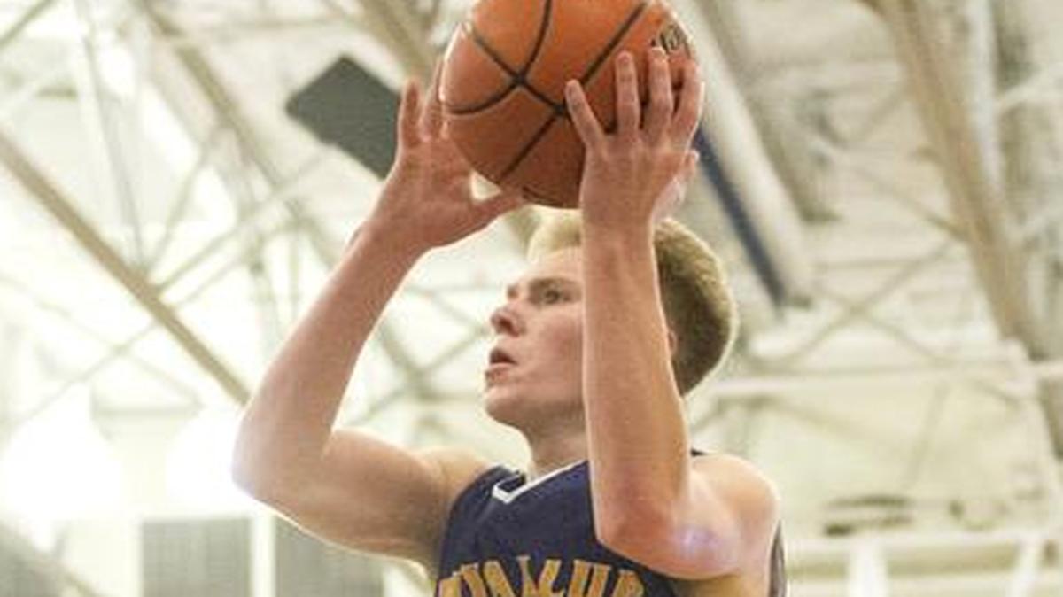 Puyallup’s Jaden Vollmen soars on a layup attempt as Sindou Diallo of Curtis defends during a game last season. Vollmen will play for the Bellevue College Bulldogs this winter after leaving as the all-time assists leader (505) for the Puyallup Vikings boys basketball program.