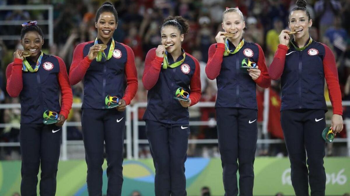 U.S. gymnasts, from left, Simone Biles, Gabrielle Douglas, Lauren Hernandez, Madison Kocian and Aly Raisman hold their gold medals during the medal ceremony Aug. 9 for the artistic gymnastics women’s team at the 2016 Summer Olympics in Rio de Janeiro, Brazil.