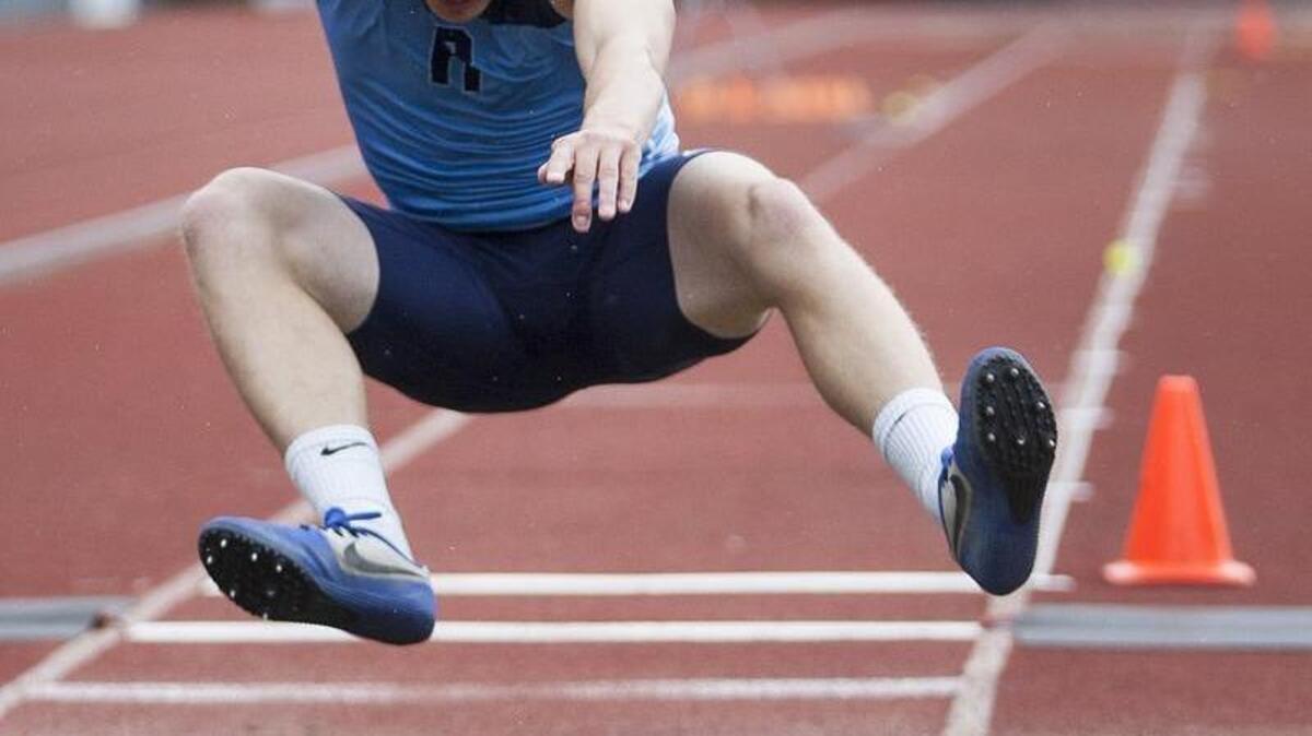 Rogers’ Loren Mark competes in the long jump event during the Class 4A West Central/Southwest District meet May 19 at French Field.