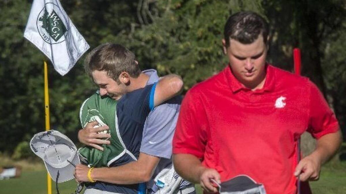 Chase Carlson gets congratulation from his caddie after winning the 90th Washington State Men’s Amateur golf tournament at Tacoma Country and Golf Club on Aug. 11. Derek Bayley, right, walks away downcast after loosing on the sixth hole of sudden death.
