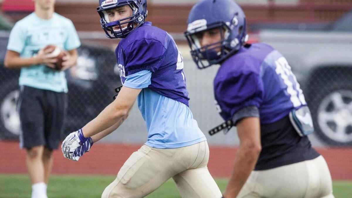 Puyallup High receiver Tallon Yerbury, left, lines up during practice at Sparks Stadium in Puyallup. Targets such as Yearbury (6-foot-2), Darius Morrison (6-foot-3) and Landen Neff (6-foot-2) are being added to quarterback Nathaniel Holcomb’s favorite target, Noah McFadden (5-foot-10). Already bursting at the seams with big-bodied receivers, Puyallup has the ability to add one more after Gavin Dunasky and his 6-foot-6 frame get more reps with the offense.