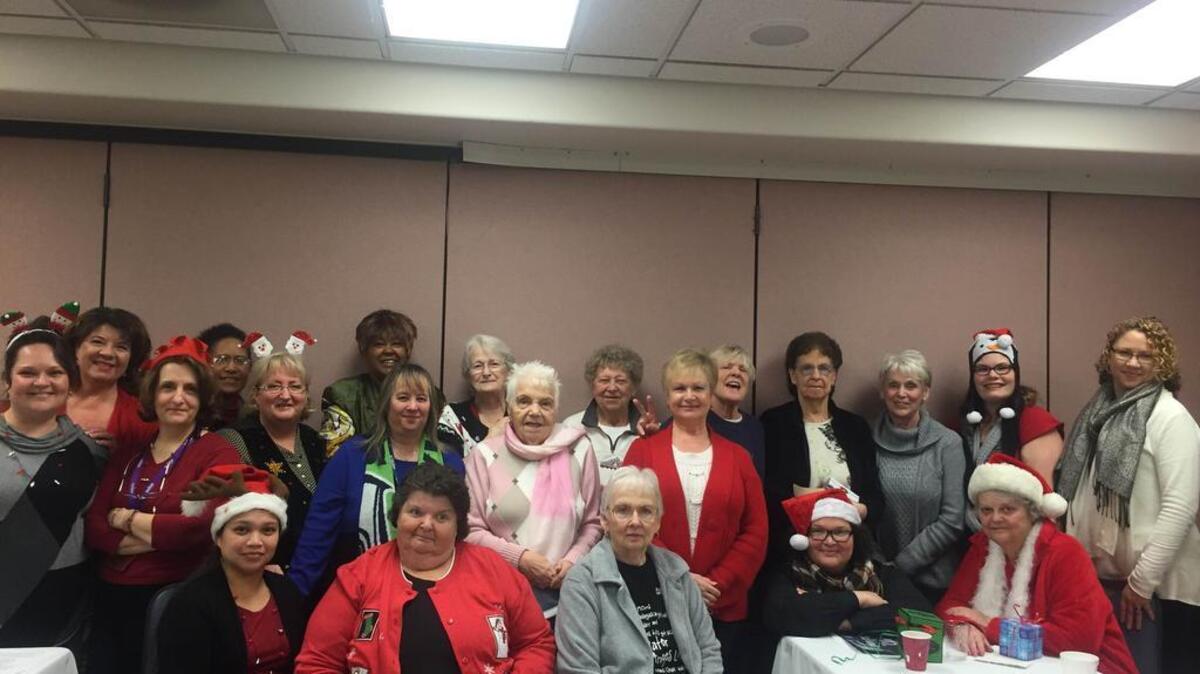 Members of the Sumner Commons, a low-income housing community for seniors, gather for a photo last week. Aging with Excellence, a local nonprofit, gave each of the 34 seniors in the community a $100 gift card to Fred Meyer.