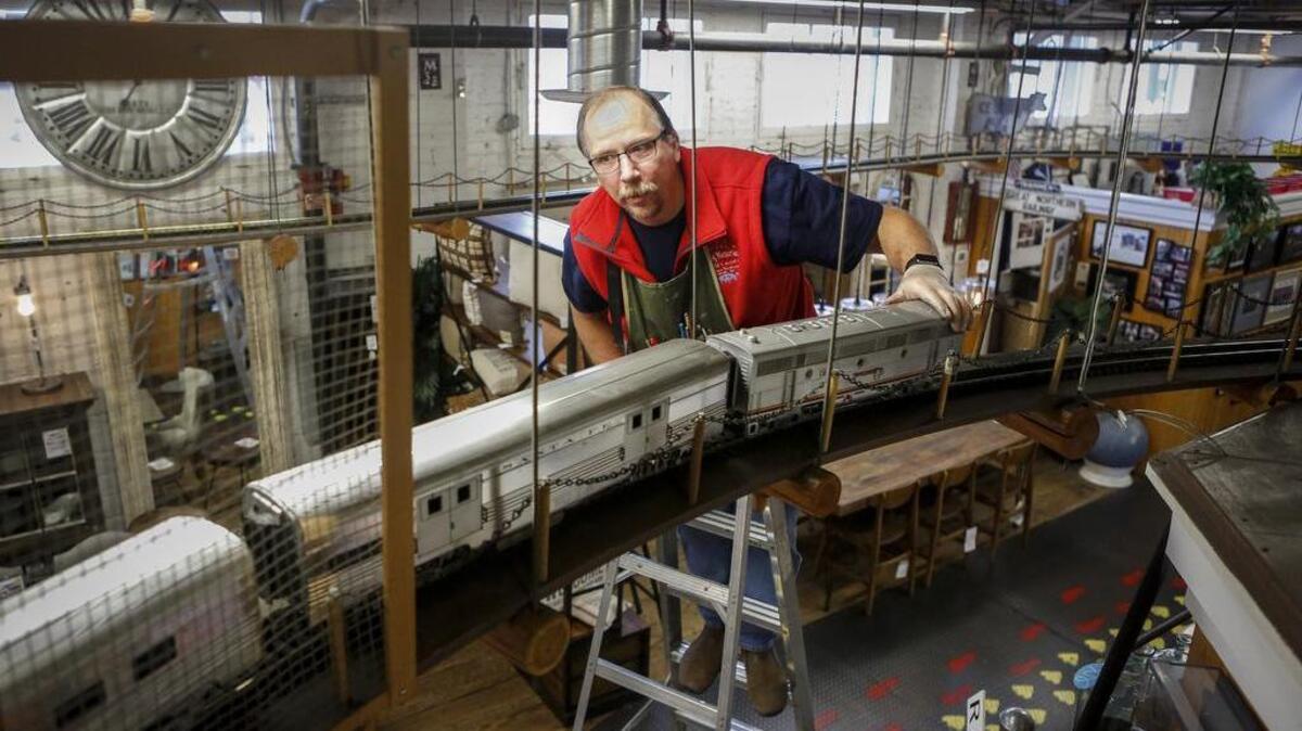 JT Gehrke replaces a locomotive on a G Scale Sante Fe Super Chief on the track last week at The Old Cannery Furniture Warehouse in Sumner.