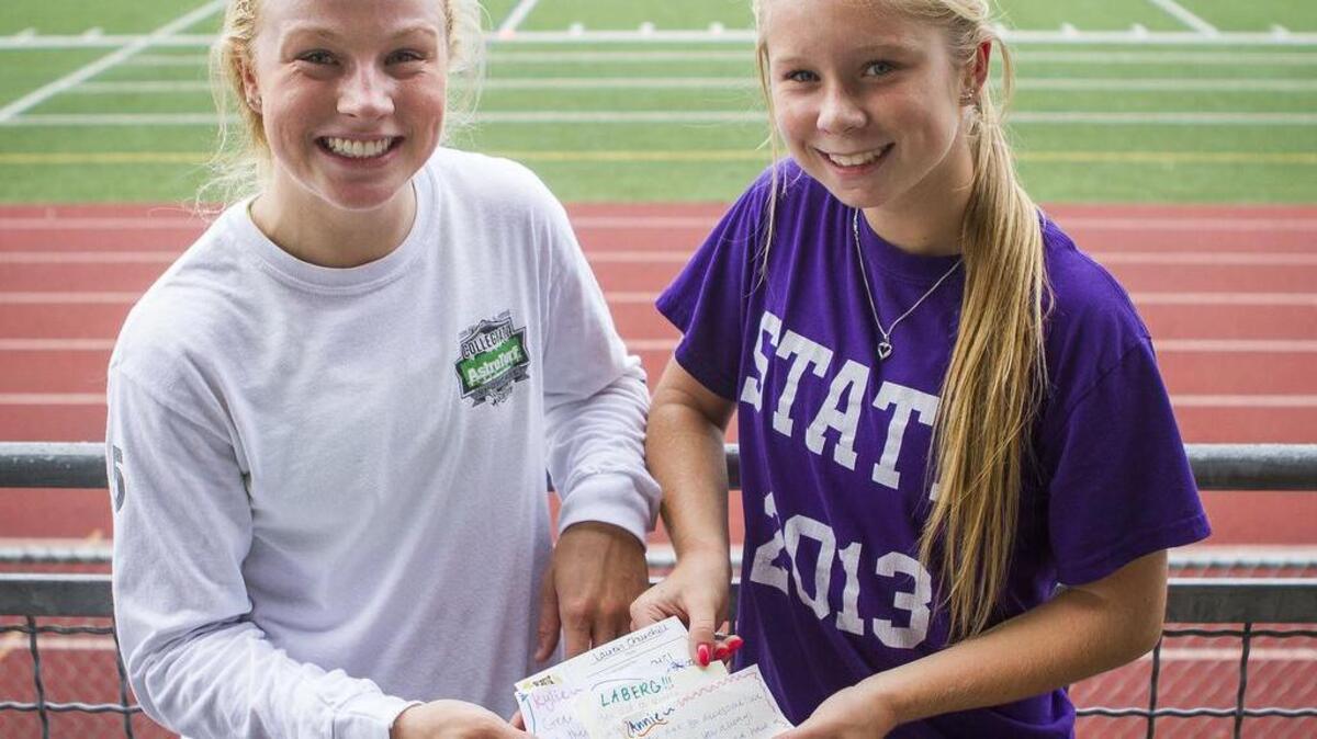 Sumner High School girls soccer team captain Jordan Thompson, left, and teammate Hannah Rowan holds notes they wrote for girls trying out for the soccer team.
