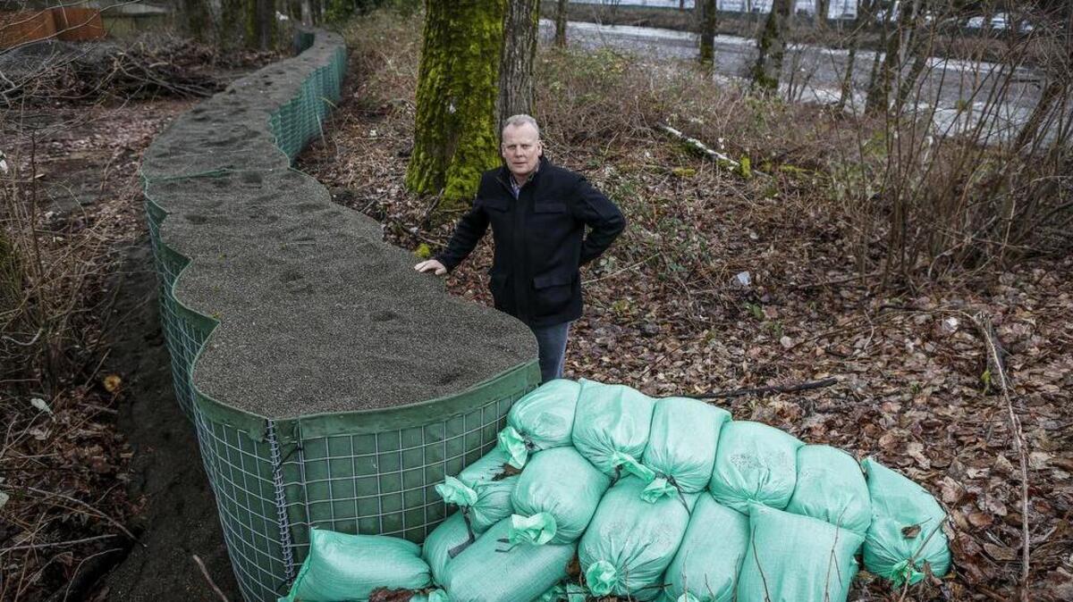 Project manager Doug Beagle stands next to recently installed hescoes meant for flood protection from the White River in Sumner.