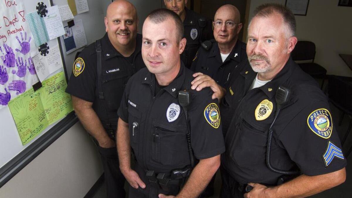 The Sumner Police Department has recently received an outpouring of community support in the form of cards, baked goods, flowers and letters. Sumner Police Department Chaplain Bob Ihler also teamed up with a local pastor to organize a formal prayer time. From left: Officer Loren Houselog, Officer Marcus McDonald, Sgt. Gary Backus, Chaplain Bob Ihler and Officer Matt Watson stand for a portrait at the Sumner Police Department.