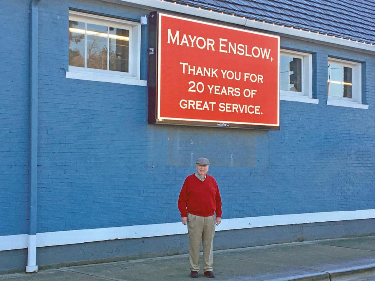 Sumner Mayor Dave Enslow stands under a sign honoring his service to the city at The Old Cannery.