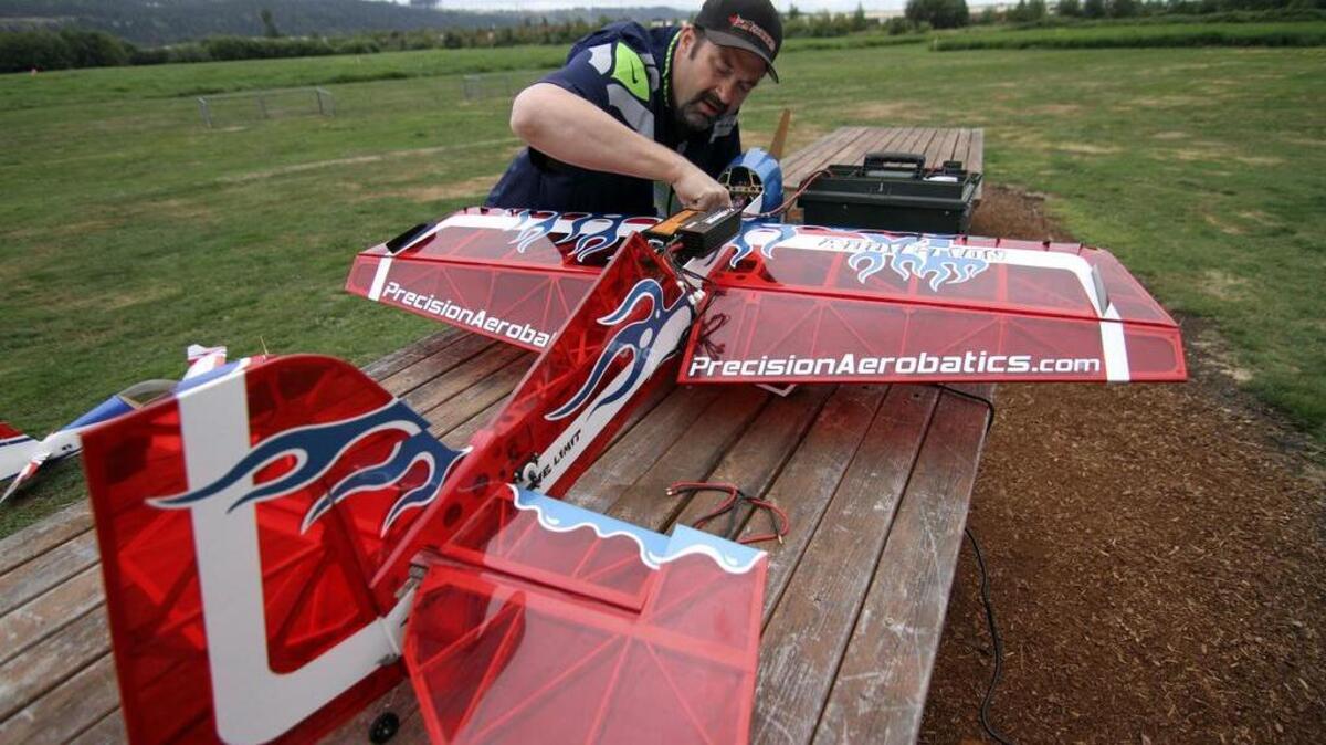 
Matt Mikko, the Radio Aero Modelers Club of Seattle’s safety officer and remote-controlled pilot and builder, works on his airplane before flying last week.
