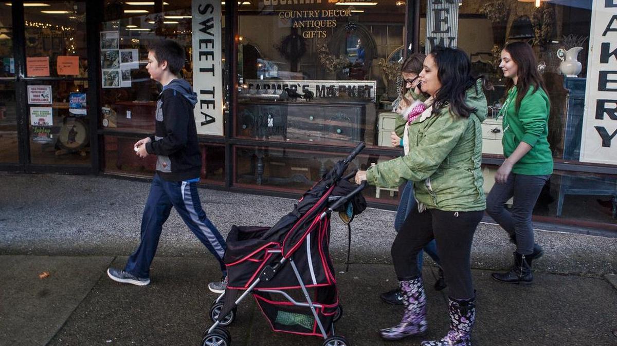Jesse, left, Jessica, center, Lily, center, and Lily Haeder walk through downtown Sumner hiding painted rocks.