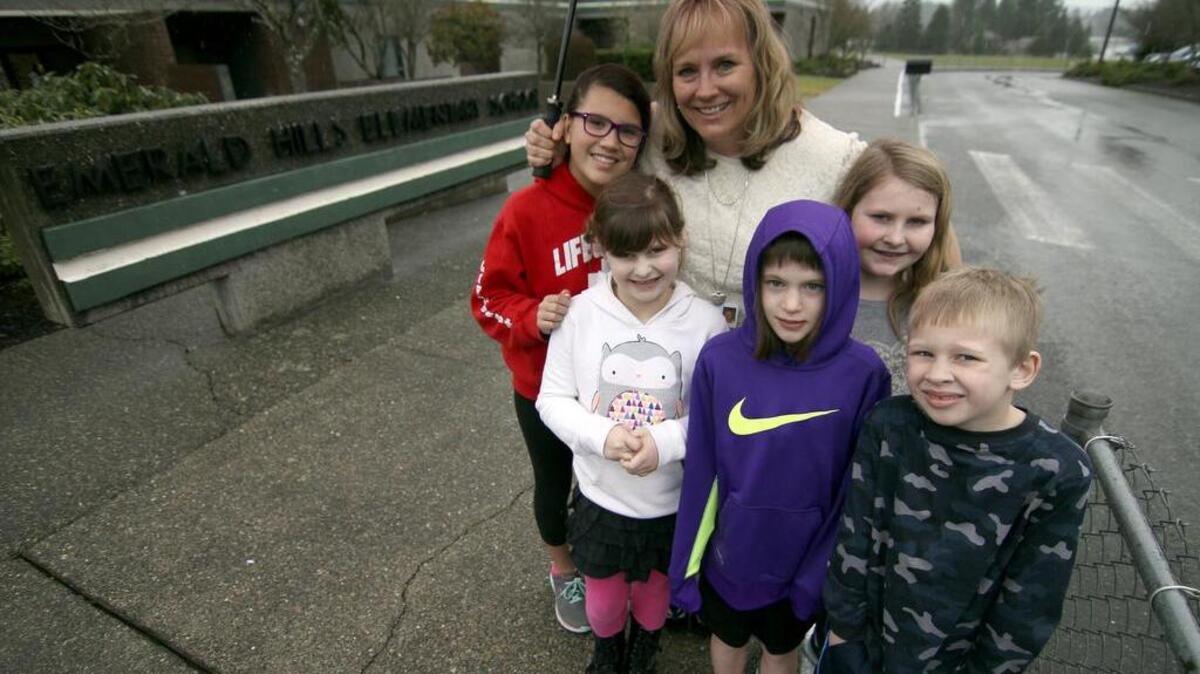 Emerald Hills Elementary School Principal Andrea Landes poses with some of her students at the Bonney Lake school. Area voters recently approved a bond measure that will rebuild the school.