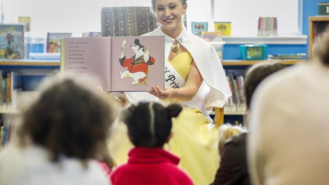 Daffodil Princess Jane McDonald reads to children during a visit Saturday at the Pierce County Library in Sumner.