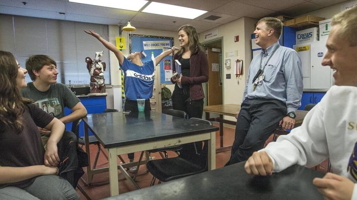 Sumner School District created a video series called “The Heart of Teaching,” meant to recognize teachers making a difference in students’ lives. Boe Woodbury, second from right, a science teacher at Sumner High School, was one of three featured teachers. Woodbury, connecting with students before a recent class, said forming relationships with individual students was one of the most important priorities in his approach to teaching.