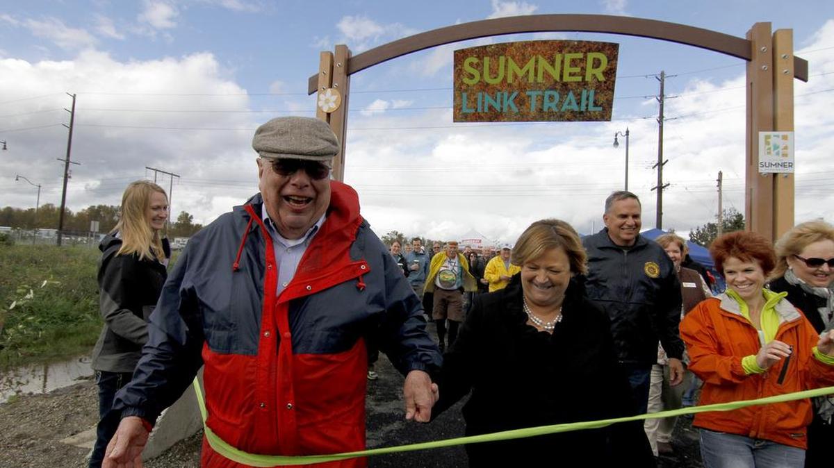 Sumner Mayor Dave Enslow celebrates with attendees the opening of the Sumner Link Trail. The trail is part of a larger system of connecting communities bike and walking routes that stretch from the InterUrban Trail and feeds into the Puyallup area. The completion of the trail is just one of the many projects Enslow has overseen during his two decades serving the city of Sumner.