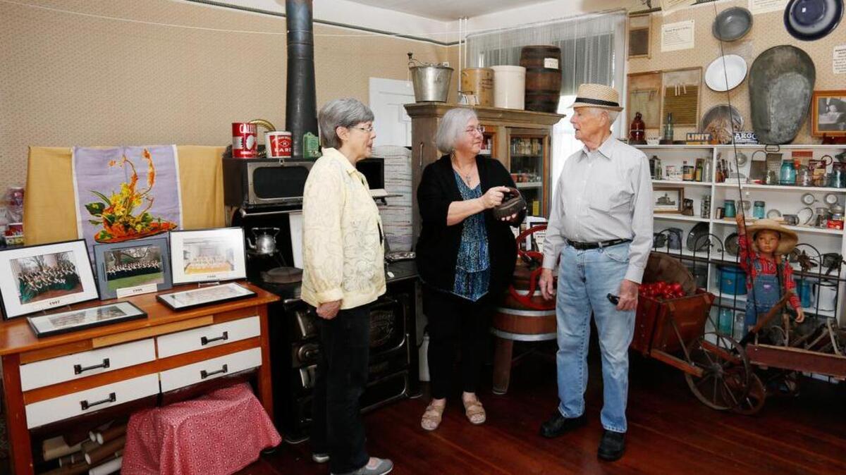 Ryan House Museum volunteers Pam Prasch, Vicki Connor and former Sumner City Council member Leroy Goff, from left, share fond memories at the museum in Sumner.