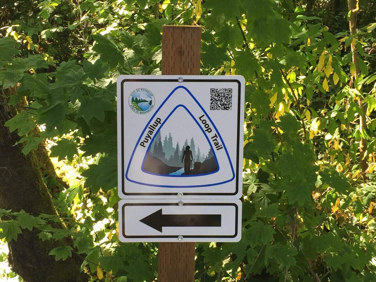 Signs placed along Puyallup’s finished Clarks Creep Loop Trail keep walkers and joggers on the five-mile path.