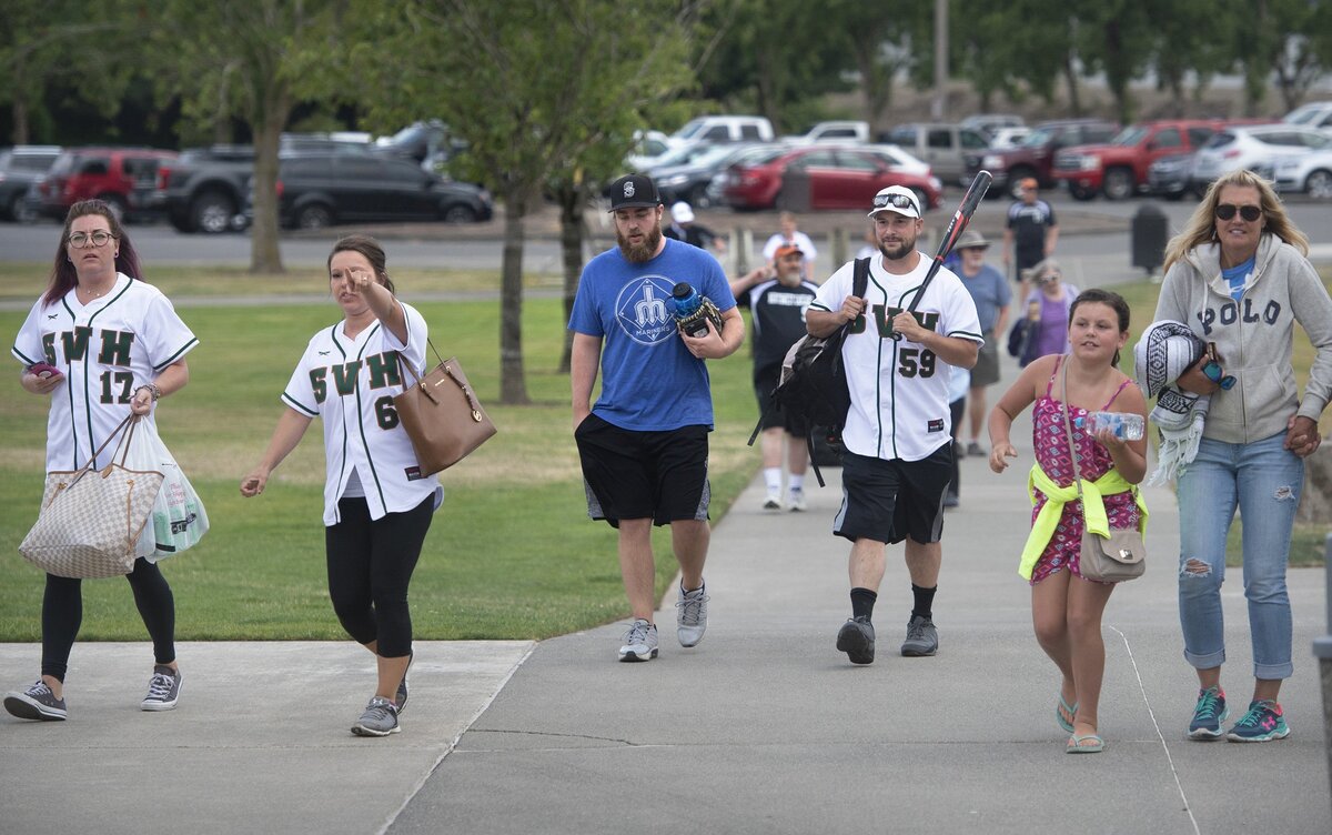 Players and families arrive for the opening night of summer league softball games at Puyallup Recreation Center on Valley Avenue on Thursday, July 19.
