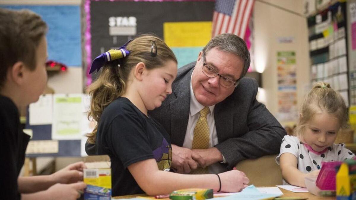 U.S. Rep. Denny Heck, D-Olympia, meets with Jacob Reich, from left, Hailey Stoch and Haylee Orr, right, as they work on valentines for first responders and veterans at Maplewood Elementary School in Puyallup Friday.
