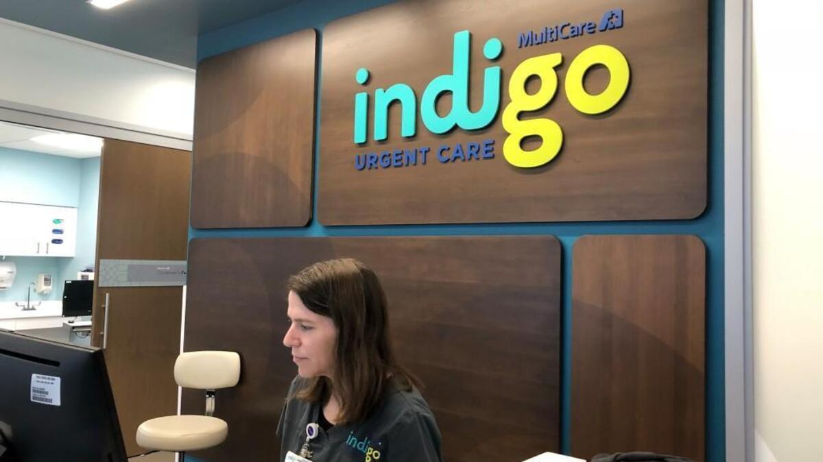 Medical assistant and clinical concierge Christina Searles works behind the counter at the MultiCare Indigo Urgent Care clinic in South Hill.