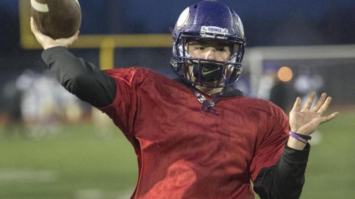 Quarterback Nathaniel Holcomb works out at practice last week.