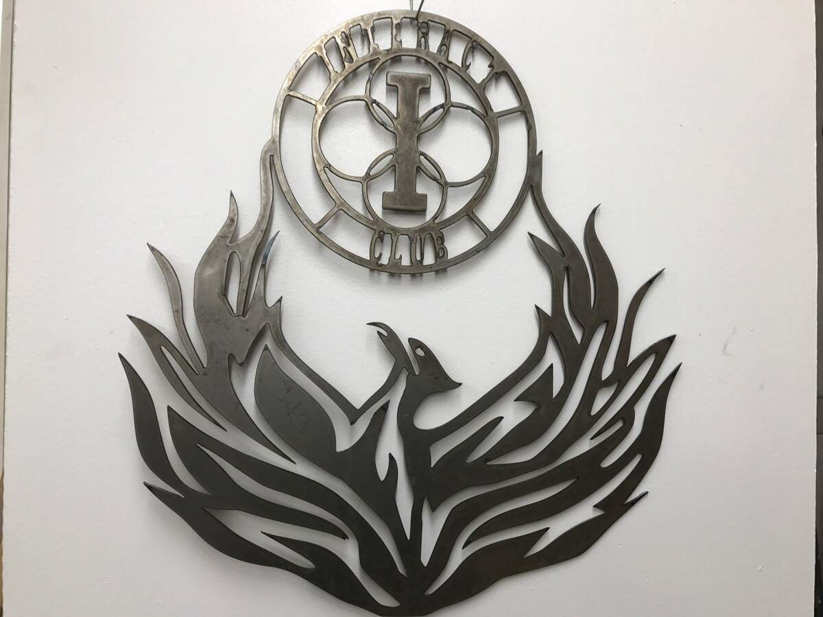 A metal art piece donated to Elhi Hill High School by Sumner resident Ron Haines hangs in his studio.