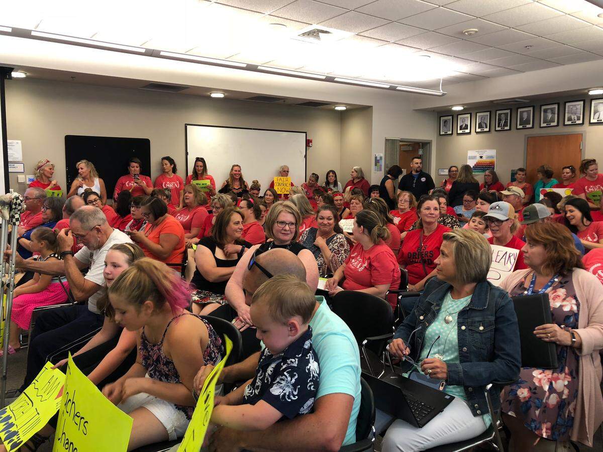 Sumner Education Association teachers, bus drivers and food service employees crowd the Sumner School District board meeting on Aug. 15 to speak to the school board about increased wages.
