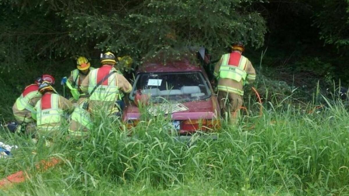 Wendy Blanton’s Honda Accord rests in the trees off state Route 7 near Graham on June 4. She and her passenger were trapped in the car for approximately seven hours, according to court documents.