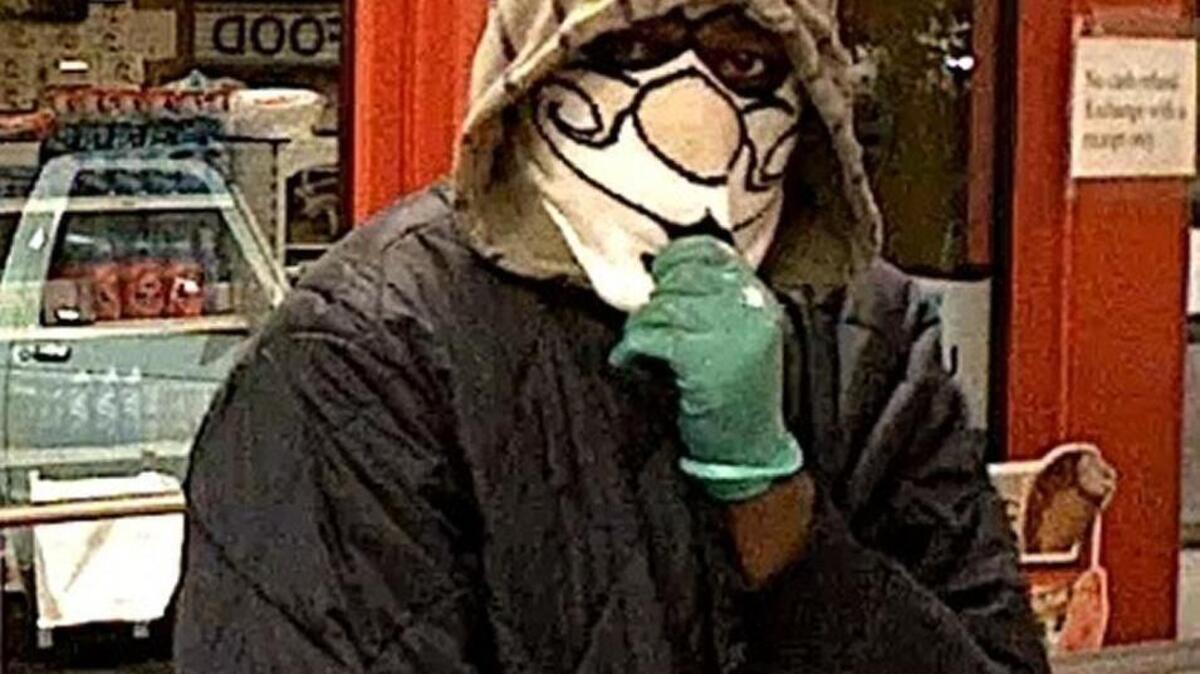 Detectives are trying to identify a man who robbed a Parkland gas station last month while wearing a Santa mask.