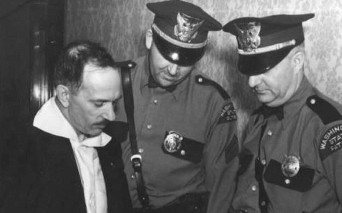 Washington State Patrol officers review crime scene photographs from the kidnapping of Tacoma’s Charles Mattson with an unidentified man. Mattson, 10, was kidnapped for ransom on Dec. 27, 1936. His battered body was recovered Jan. 10, 1937 in Everett. His murder was never solved. Frank Olson, a mental patient at Medical Lake Asylum, confessed to kidnapping the Mattson boy. Olson, also known as Lester Mead and Charles Thorp, was found harmless and was returned to the asylum after two days of questioning by the State Patrol at the Winthrop Hotel.