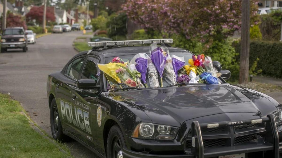 A Lakewood Police car is adorned with flowers as it sits parked in Fircrest, April 29, 2017. It is a memorial to Arron Grant, a Lakewood officer who killed himself April 25.