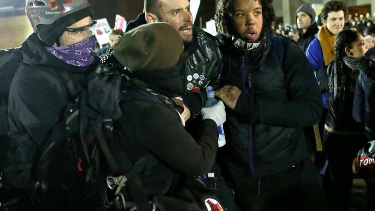 A man suffering from a gunshot wound is assisted at a protest at the University of Washington in Seattle on Friday.