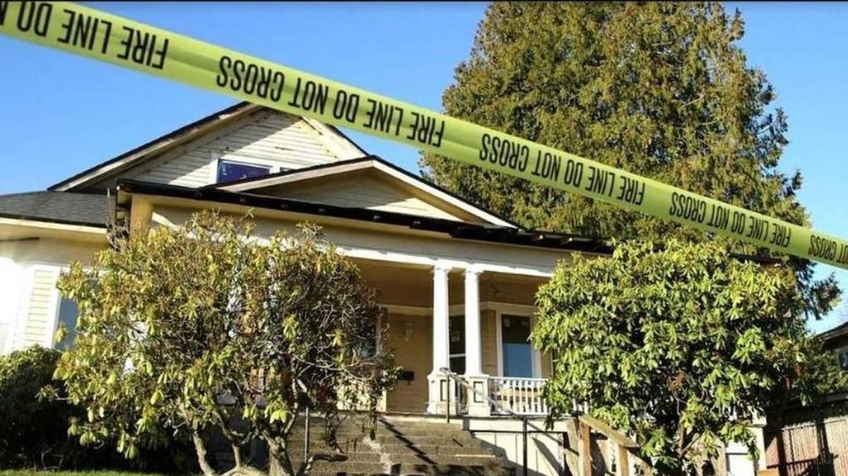 A house in Tacoma’s Lincoln District is wrapped in police tape Friday after two bodies were discovered inside after a fire.