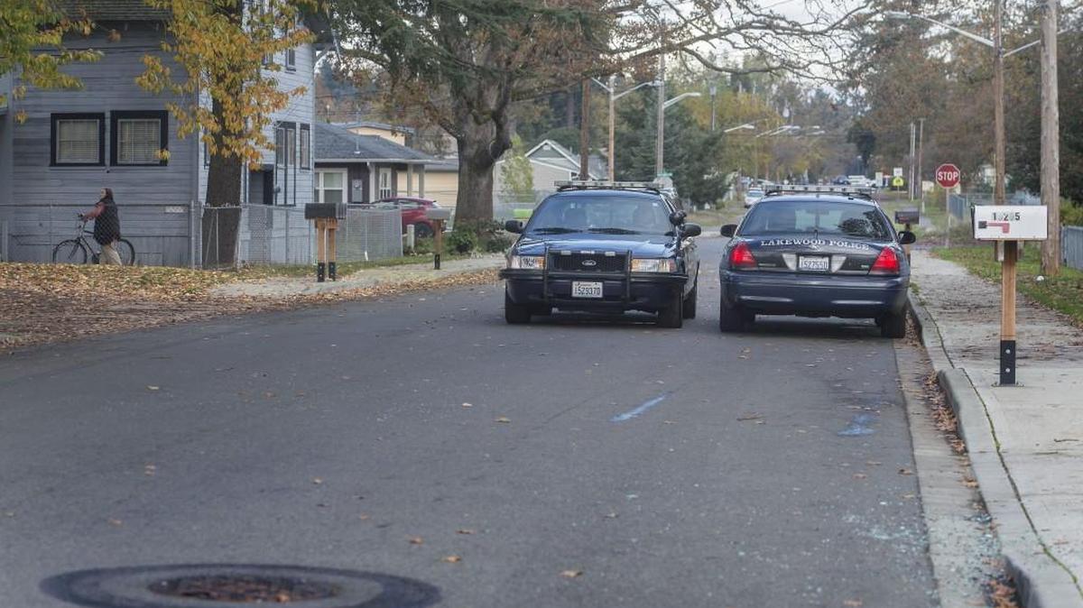 Two Lakewood Police squad cars are parked at the scene Thursday, Nov. 5, 2015, of a shooting on Grant Avenue Southwest in Tillicum.