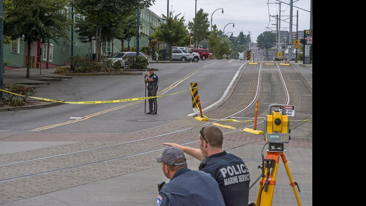 Tacoma police survey the scene of a fatal bicycle collision Friday at the corner of East 24th and G streets, near the Tacoma Dome Transit Center, July 24, 2015.