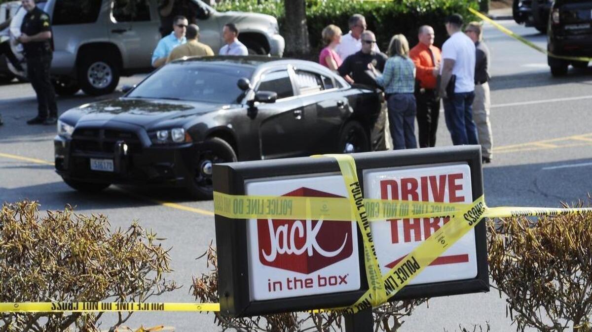 
A multi-agency, law enforcement response team investigates the officer-involved shooting at the Jack in the Box restaurant Tuesday  after Tumwater police responding to a reported 4:30 p.m. hostage incident shot one suspect.
